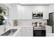 Modern kitchen with stainless steel appliances and white cabinets at 6125 25Th S St, St Petersburg, FL 33712