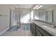 Elegant bathroom with granite countertop, double sinks, and a soaking tub at 6337 Waves End Pl, Apollo Beach, FL 33572