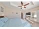 Spacious bedroom with a large bed, ceiling fan, and access to a bathroom at 6337 Waves End Pl, Apollo Beach, FL 33572