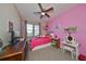 Bright bedroom with a full-size bed and a vanity area at 6337 Waves End Pl, Apollo Beach, FL 33572