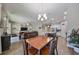 Casual dining area with wood table and chairs, open to the living room and kitchen at 6337 Waves End Pl, Apollo Beach, FL 33572