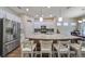 Modern kitchen with stainless steel appliances and large granite island at 6337 Waves End Pl, Apollo Beach, FL 33572