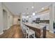 Modern kitchen with white cabinets, granite island, and stainless steel appliances at 6337 Waves End Pl, Apollo Beach, FL 33572