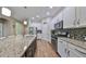Spacious kitchen with granite countertops, stainless steel appliances, and an island at 6337 Waves End Pl, Apollo Beach, FL 33572