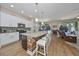 Open concept kitchen with island seating, stainless steel appliances, and views to the living room at 6337 Waves End Pl, Apollo Beach, FL 33572