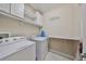 Convenient laundry room with washer, dryer, and cabinets at 6337 Waves End Pl, Apollo Beach, FL 33572