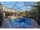 Resort-style screened pool with diving board, and plenty of space to relax at 6337 Waves End Pl, Apollo Beach, FL 33572