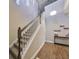 Elegant staircase with wooden railing and chandelier at 6337 Waves End Pl, Apollo Beach, FL 33572