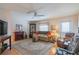 Living room with hardwood floors, fireplace, and ample natural light at 709 W Brockton Pl, Sun City Center, FL 33573