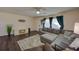 Cozy living room with L-shaped sofa and wood-look floors at 7236 Landover Dr, Zephyrhills, FL 33540