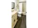 Bright bathroom featuring granite countertops, a shower-tub, and dark wood flooring at 9107 Lingrove Rd, Weeki Wachee, FL 34613