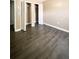 Spacious bedroom features neutral walls, dark flooring, and closet with white doors at 9107 Lingrove Rd, Weeki Wachee, FL 34613