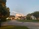 Charming single-story homes line a neighborhood street with mature trees and well-maintained lawns under a beautiful sky at 9107 Lingrove Rd, Weeki Wachee, FL 34613