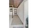 Covered front entrance with a black front door, white textured walls, and a 'WELCOME' sign at 9107 Lingrove Rd, Weeki Wachee, FL 34613