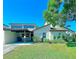 Charming single Gathering home featuring a well-manicured lawn and a covered carport at 9107 Lingrove Rd, Weeki Wachee, FL 34613