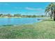 Beautiful lake view featuring a dock and waterfront living surrounded by lush greenery at 9107 Lingrove Rd, Weeki Wachee, FL 34613