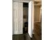 A laundry closet with white bi-fold doors revealing a stackable washer and dryer at 9107 Lingrove Rd, Weeki Wachee, FL 34613