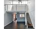 Bright living room with ceiling fan, stairs to loft, and view into the kitchen with pass through window at 9107 Lingrove Rd, Weeki Wachee, FL 34613
