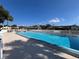 Community pool featuring crystal clear water, surrounded by a white picket fence and comfortable lounge furniture at 9107 Lingrove Rd, Weeki Wachee, FL 34613