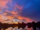 Stunning sunset over a lake reflects vibrant colors in the sky at 9107 Lingrove Rd, Weeki Wachee, FL 34613