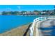 Serene lake view with waterfront homes featuring private docks and calm blue water, enhancing the tranquil neighborhood at 9107 Lingrove Rd, Weeki Wachee, FL 34613