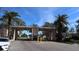 Community entrance with gated access and palm trees at 9950 62Nd N Ter # 316, St Petersburg, FL 33708