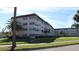 Condo building with palm trees and parking at 9950 62Nd N Ter # 316, St Petersburg, FL 33708