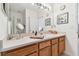 Bathroom with double sinks, wood cabinets and large mirror at 1020 Blackwater Dr, Wesley Chapel, FL 33543