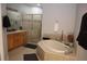 Elegant bathroom featuring a soaking tub, shower, and double vanity at 10405 Saint Tropez Pl # 10405, Tampa, FL 33615