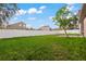 Spacious backyard with grassy lawn, privacy fence, and a patio area at 11240 Ragsdale Ct, New Port Richey, FL 34654