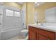 Bathroom with tub, toilet and wood cabinets at 11240 Ragsdale Ct, New Port Richey, FL 34654