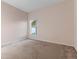 Bedroom with window, neutral walls, and carpeted floor at 11240 Ragsdale Ct, New Port Richey, FL 34654