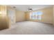 Spacious bonus room with carpeted floor, ceiling fan, and large window at 11240 Ragsdale Ct, New Port Richey, FL 34654