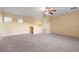 Bright bonus room featuring carpeted floors and a ceiling fan at 11240 Ragsdale Ct, New Port Richey, FL 34654
