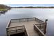 Picturesque view of a lake with a well-maintained wooden dock, ideal for fishing or enjoying the waterfront at 11240 Ragsdale Ct, New Port Richey, FL 34654