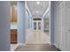 Light and airy entryway with tile floors and neutral walls at 11240 Ragsdale Ct, New Port Richey, FL 34654