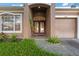Double-door entry to the house with a decorative plant at 11240 Ragsdale Ct, New Port Richey, FL 34654