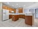 Modern kitchen featuring wood cabinets, an island, and stainless steel appliances at 11240 Ragsdale Ct, New Port Richey, FL 34654