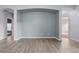 Spacious living room with light gray walls and wood-look flooring at 11240 Ragsdale Ct, New Port Richey, FL 34654