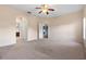 Main bedroom with carpet, ceiling fan, and access to bathroom and closet at 11240 Ragsdale Ct, New Port Richey, FL 34654
