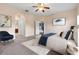 Main bedroom with bed, carpet, ceiling fan, and walk-in closet at 11240 Ragsdale Ct, New Port Richey, FL 34654