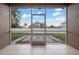 Screened-in patio with view of backyard and fence at 11240 Ragsdale Ct, New Port Richey, FL 34654