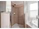 Shower stall with tiled walls and a glass door at 11240 Ragsdale Ct, New Port Richey, FL 34654