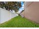 Landscaped side yard with a white vinyl fence at 11240 Ragsdale Ct, New Port Richey, FL 34654