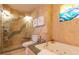 Bathroom with shower, tub, and ocean-themed art at 1390 Gulf Blvd # Ph-1, Clearwater Beach, FL 33767