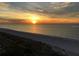 Scenic beach view at sunset with vibrant colors reflecting on the water and sand at 1390 Gulf Blvd # Ph-1, Clearwater Beach, FL 33767