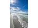 White sand beach with gentle waves under a clear blue sky at 1390 Gulf Blvd # Ph-1, Clearwater Beach, FL 33767