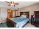 This is a bedroom with a ceiling fan, bed with a blue comforter, and two doorways to other rooms at 1390 Gulf Blvd # Ph-1, Clearwater Beach, FL 33767