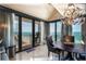 Dining room displays elegant lighting, floor-to-ceiling windows, and seating for four at 1390 Gulf Blvd # Ph-1, Clearwater Beach, FL 33767