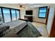 Comfortable main bedroom with ocean views, a ceiling fan, and an entertainment center at 1390 Gulf Blvd # Ph-1, Clearwater Beach, FL 33767